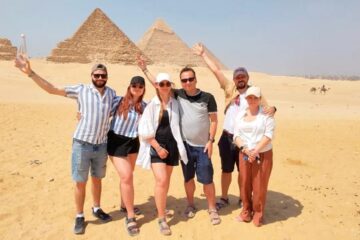 Zwei Tagesausflug von Hurghada nach Kairo mt dem Flug: Erleben Sie die Megacity mit Ihrem lokalen Insider 2 Eine glückliche Familie vor den drei Pyramiden von Gizeh bei dem Zwei Tagesausflug von Hurghada nach Kairo mit dem Flug.
